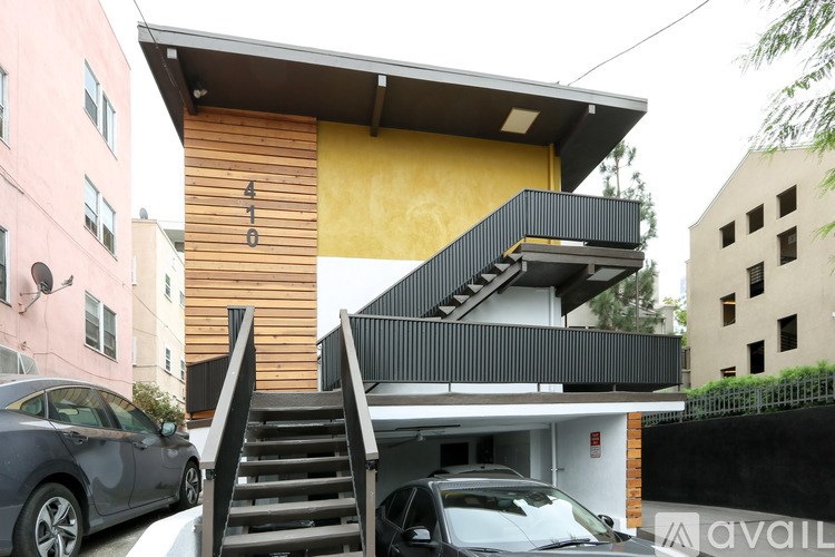 A modern house with a wooden facade and a staircase leading to the entrance.