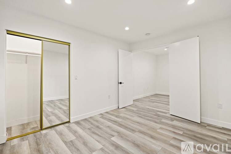 A room with a wooden floor and a white door.