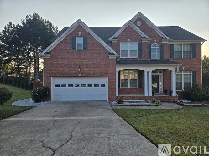 A red brick house with a white garage door.