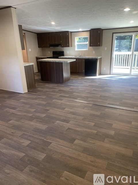 A kitchen with a wooden floor and a counter.