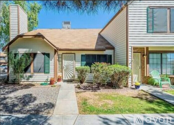 A house with a front yard and a driveway.