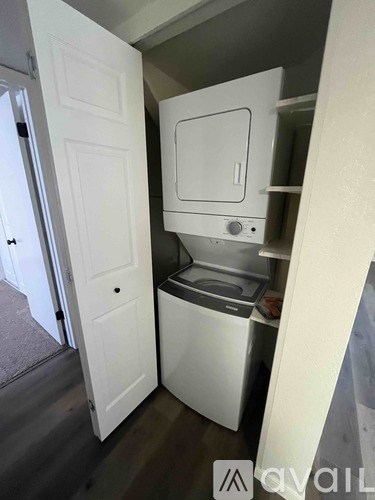 A small white kitchen with a dishwasher and a sink.