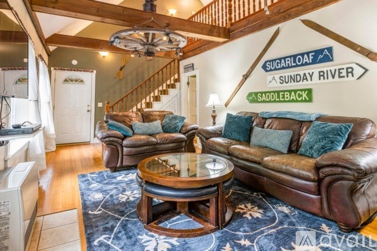 A living room with a brown leather couch and a coffee table.