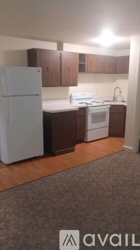 A kitchen with a white fridge and a white stove top oven.