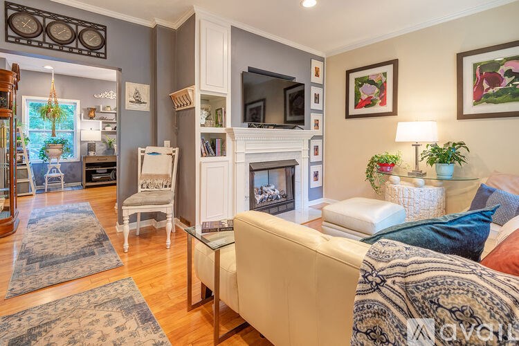 A living room with a couch, a fireplace, and a television.
