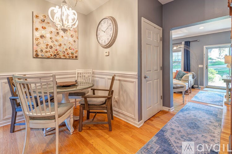A dining room with a wooden table and chairs.