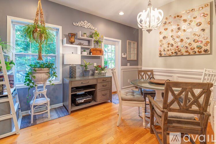 A kitchen with a wooden table and chairs.