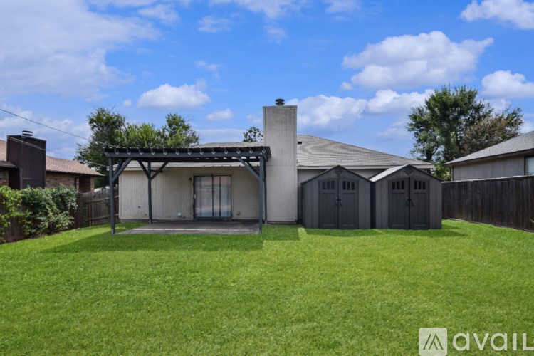 A house with a covered patio and a fence.