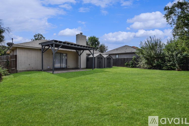 A house with a garage and a fence is available for sale.