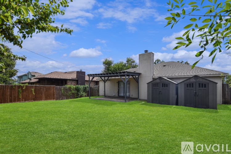 A backyard with a fence and trees.