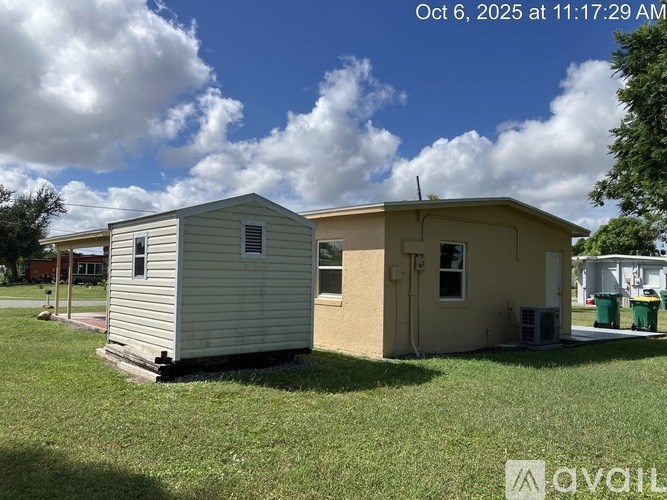 Two houses are shown in the image with a blue sky and clouds in the background.