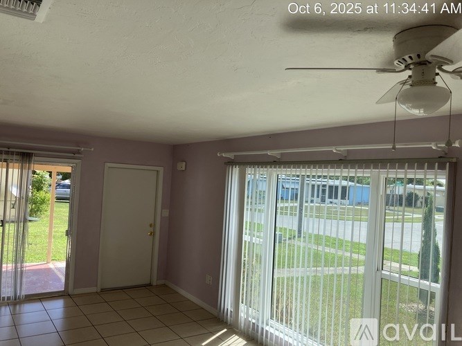 A room with a sliding glass door leading to a patio.