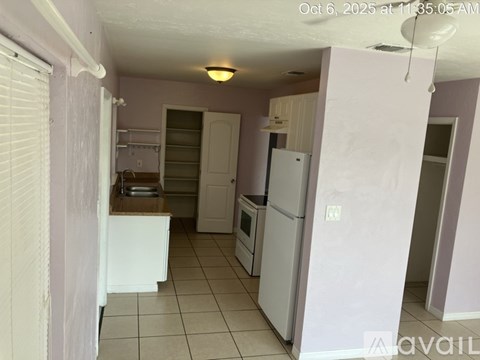 A kitchen with white appliances and a white refrigerator.