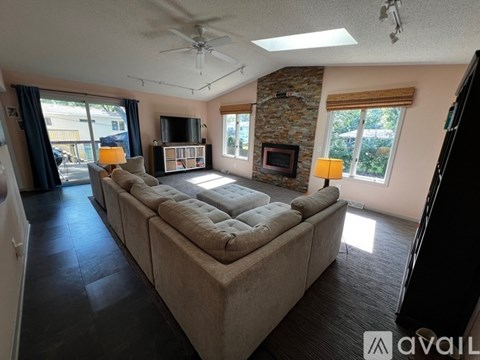 A living room with a large couch and a flat screen TV.
