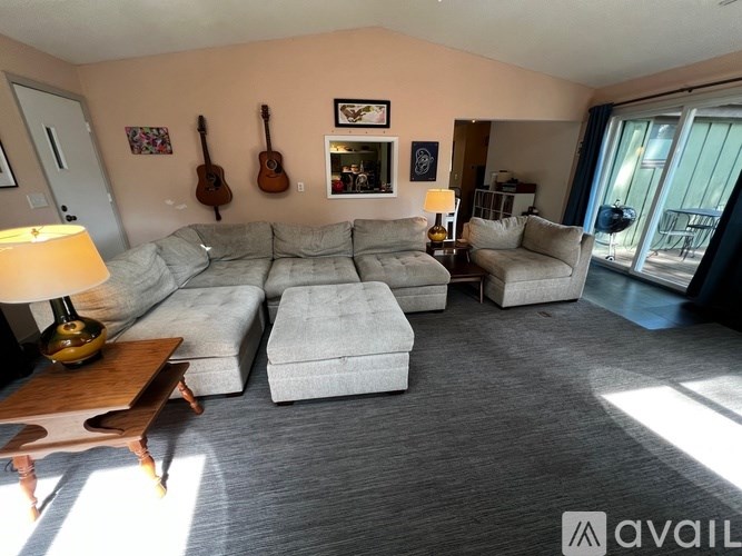 A living room with a grey sofa and a wooden coffee table.
