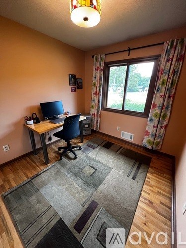 A room with a desk and a chair.