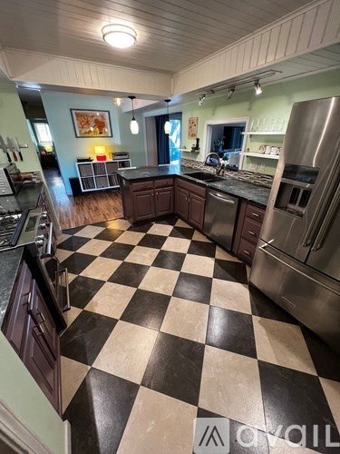 A kitchen with black and white checkered floor.