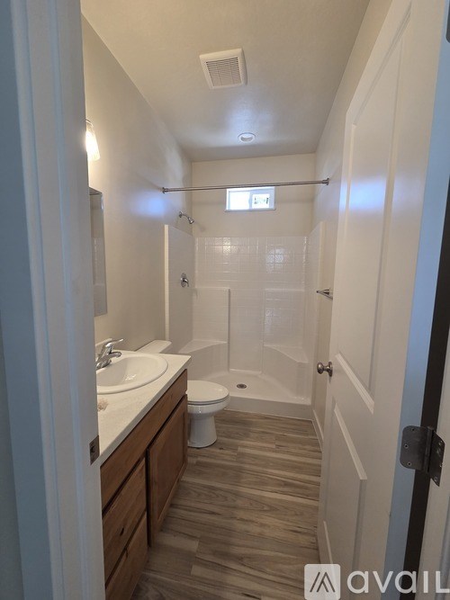A bathroom with a toilet, sink, and shower.