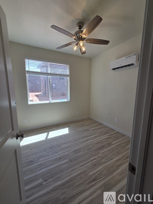 A room with a ceiling fan and a window.