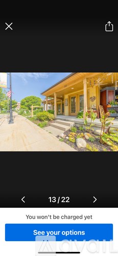 A yellow house with a red door and a flag on the left.