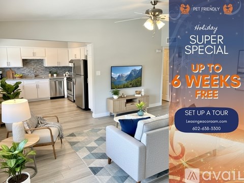 A living room with a grey couch and a television on the wall.