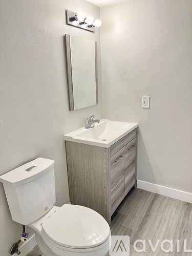 A white toilet sits next to a sink in a bathroom.