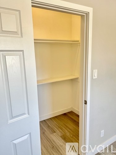 A white door with a shelf inside it.