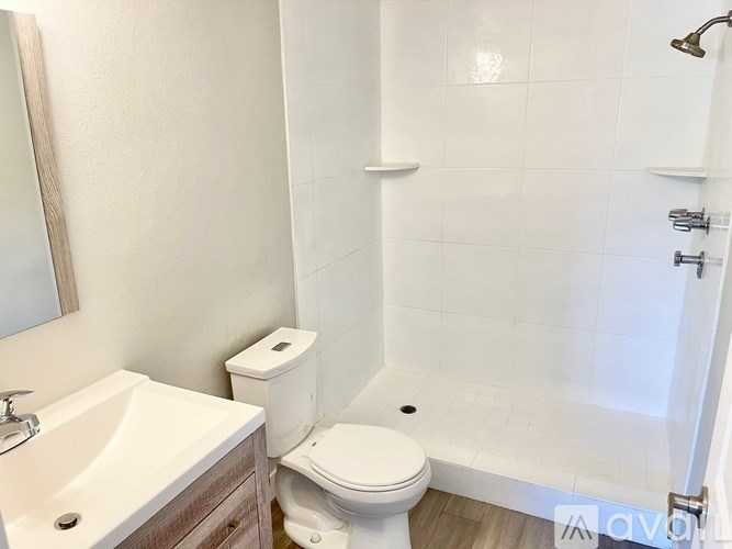 A white toilet sits next to a sink in a bathroom.