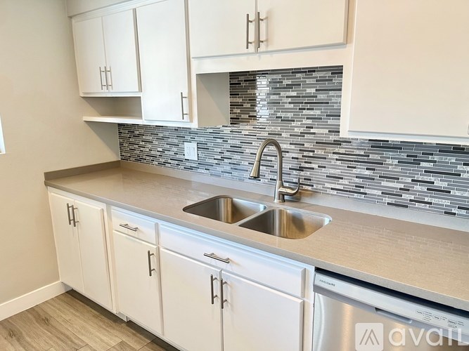 A kitchen with a sink and cabinets.