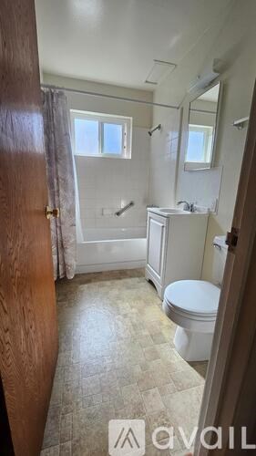 A bathroom with a toilet, sink, and shower.