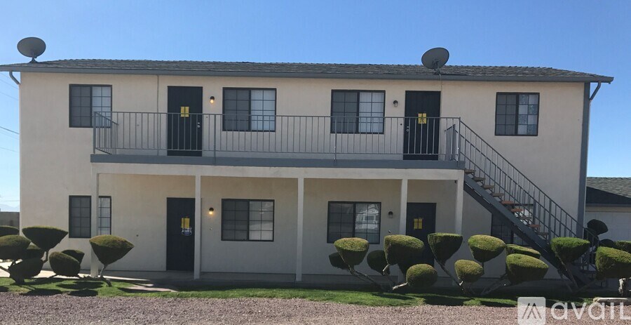 A two-story house with a balcony on the second floor.