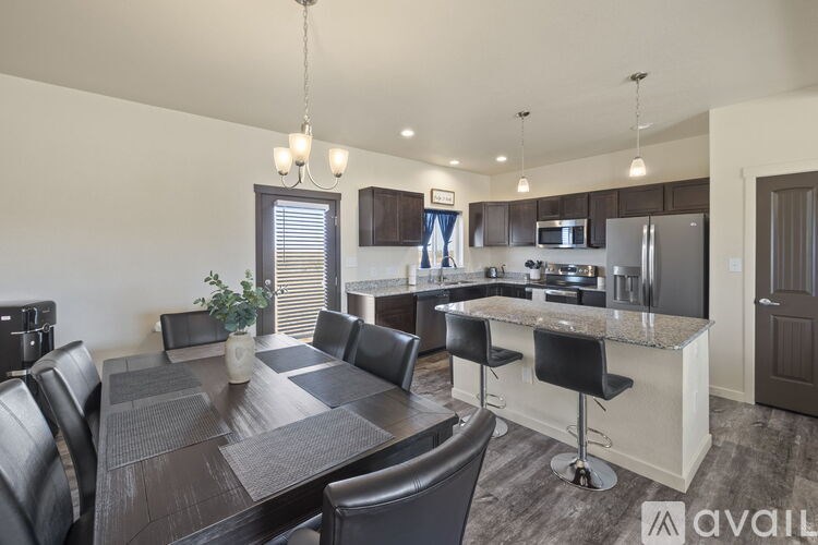 A modern kitchen with a dining table and chairs.