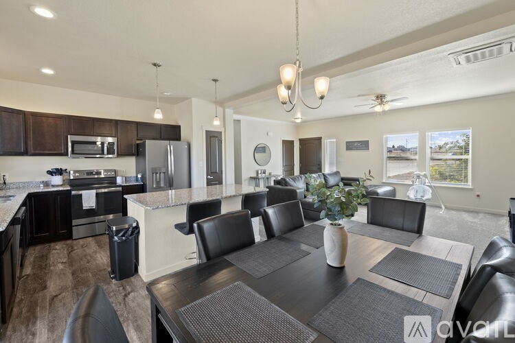 A modern kitchen with a dining table set for four.