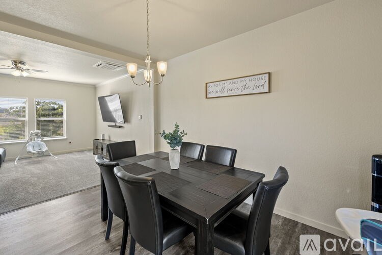 A dining room with a wooden table and chairs.
