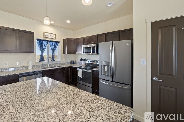 A kitchen with granite countertops and stainless steel appliances.