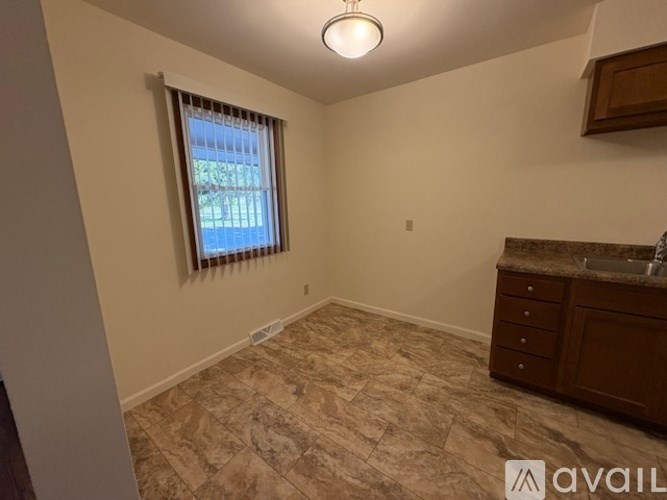 A room with a window and a sink.