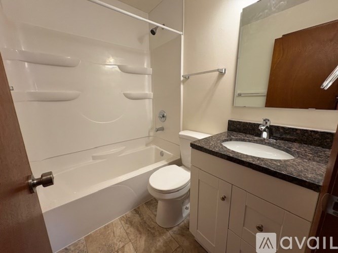 A bathroom with a toilet, sink, and bathtub.