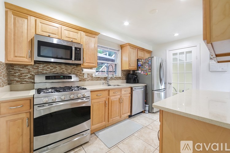 A kitchen with wooden cabinets and stainless steel appliances.