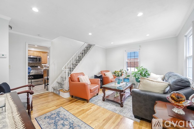 A living room with a staircase and a couch.