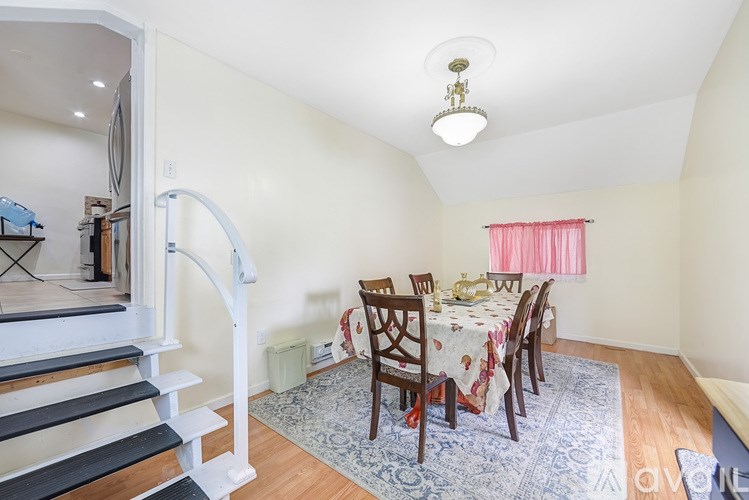 A dining room with a table set for six people.