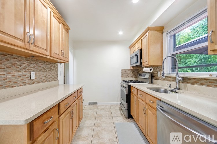 A kitchen with wooden cabinets and a brick backsplash.