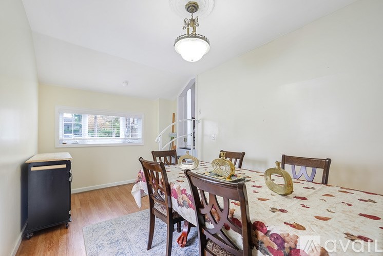 A dining room with a table set for four.