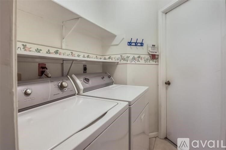 A white washing machine and dryer in a small laundry room.
