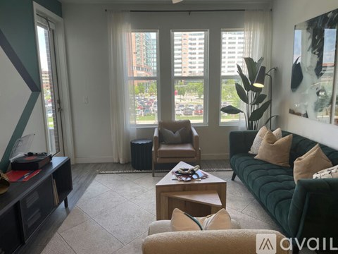 A living room with a green couch and a coffee table.
