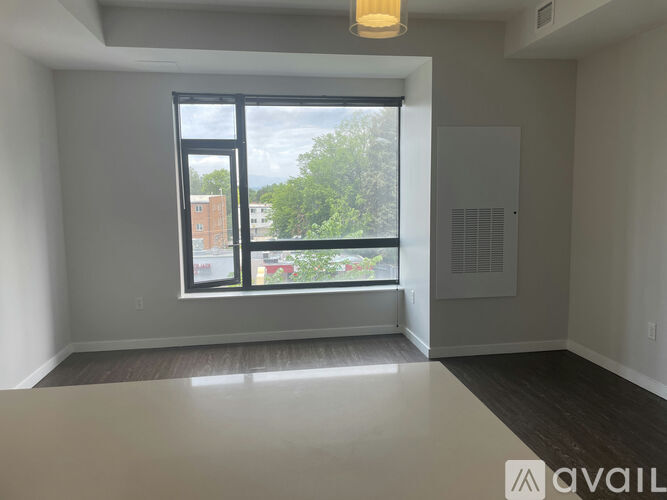 A room with a large window and a view of the outdoors.