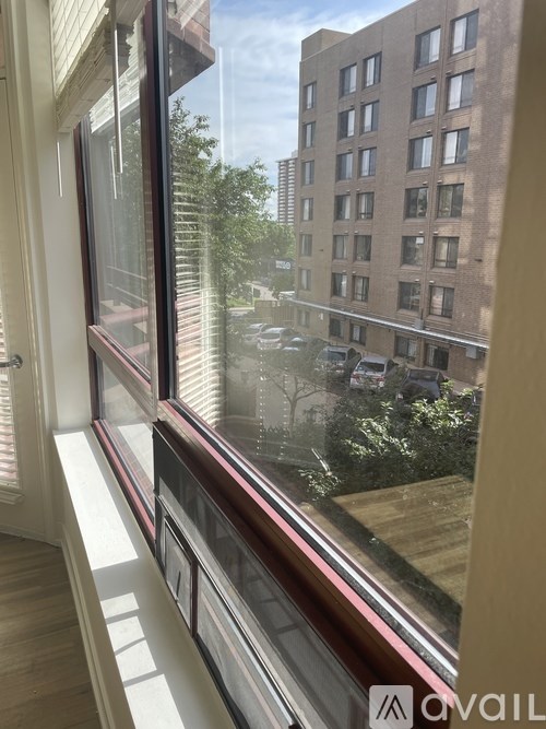 A window with a view of a building across the street.