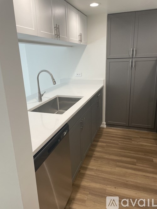 A kitchen with a sink and a dishwasher.