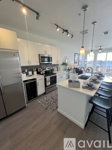 A modern kitchen with a large island and stainless steel appliances.