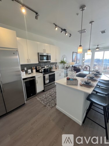 A modern kitchen with a large island and stainless steel appliances.