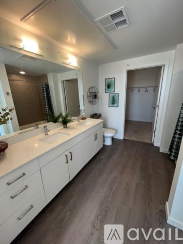 A bathroom with a sink, mirror, and toilet.